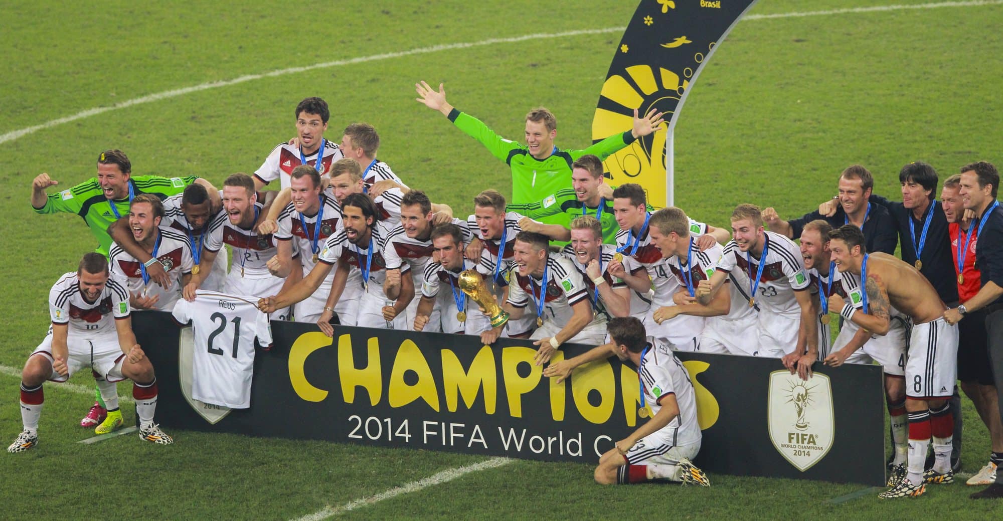 Champions lifting the World Cup trophy amid golden confetti